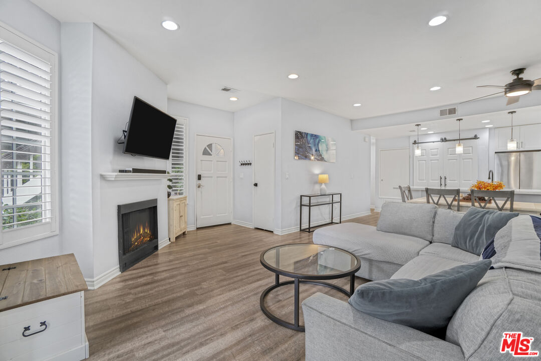 10401 Garden Grove Boulevard, Unit 44 Garden Grove, CA 92843 - Photo 2 of 26 a living room with furniture a fireplace and a flat screen tv