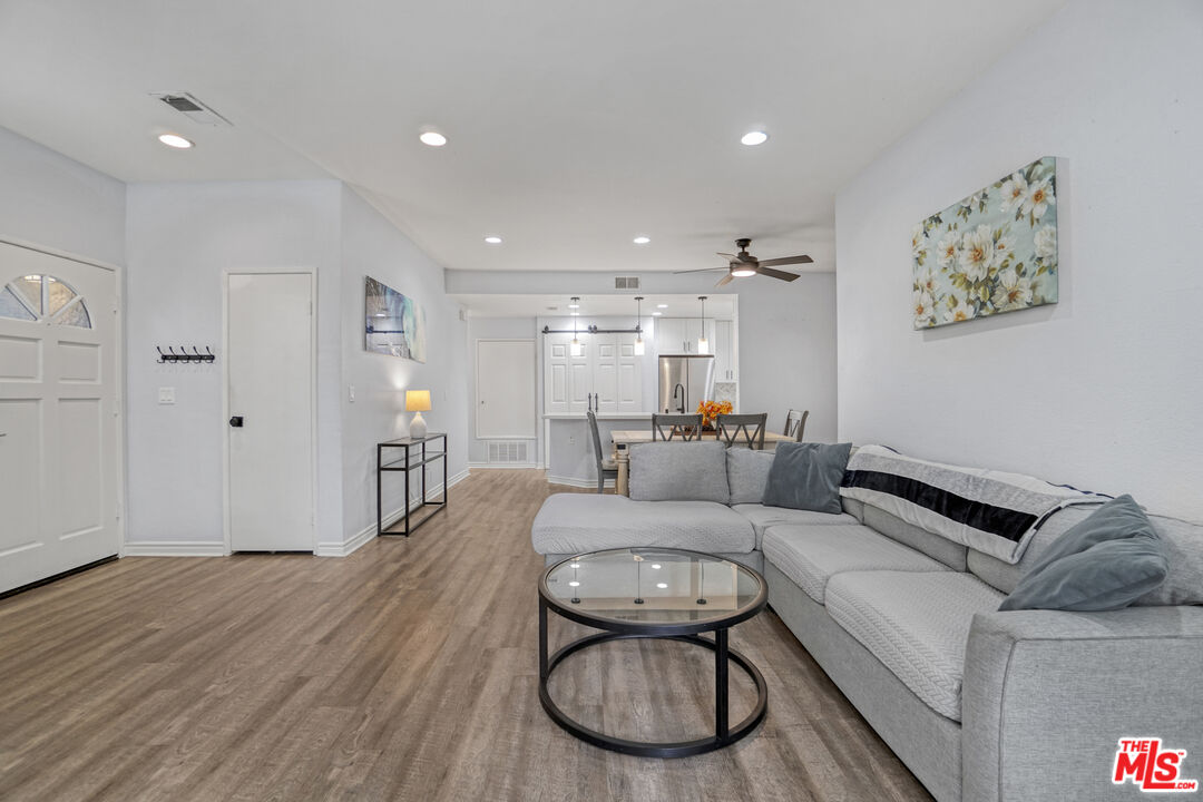 10401 Garden Grove Boulevard, Unit 44 Garden Grove, CA 92843 - Photo 5 of 26 a living room with furniture and a wooden floor