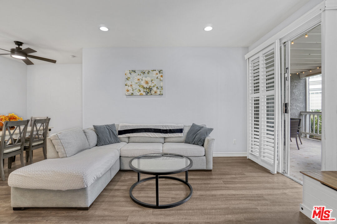 10401 Garden Grove Boulevard, Unit 44 Garden Grove, CA 92843 - Photo 6 of 26 a living room with furniture and a wooden floor