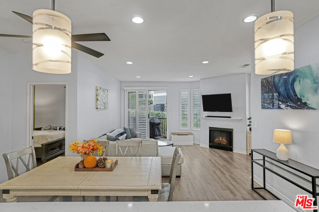 10401 Garden Grove Boulevard, Unit 44 Garden Grove, CA 92843 - Photo 8 of 26 a living room with furniture a fireplace and a flat screen tv