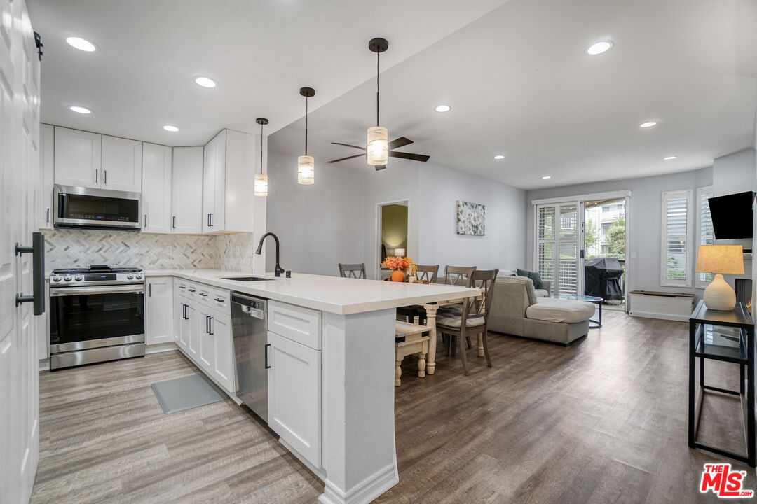 10401 Garden Grove Boulevard, Unit 44 Garden Grove, CA 92843 - Photo 10 of 26 a large white kitchen with stainless steel appliances