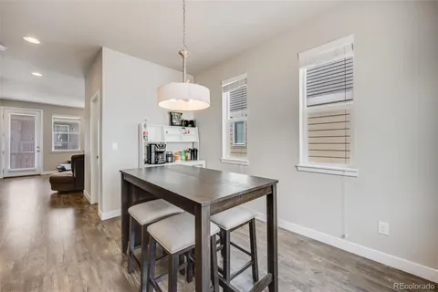 a view of a dining room with furniture wooden floor and chandelier