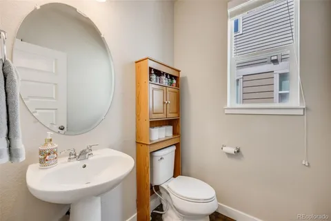 a bathroom with a sink a mirror and a toilet