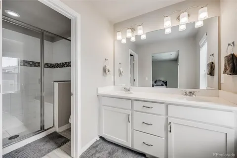 a bathroom with a double vanity sink and a mirror