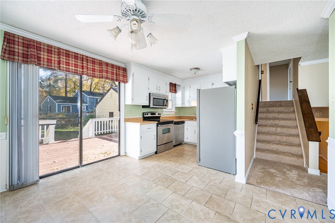 201 Monath Road Chesterfield, VA 23236 - Photo 13 of 30 a kitchen with white cabinets and stainless steel appliances