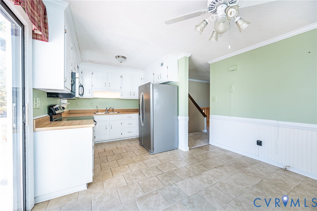 201 Monath Road Chesterfield, VA 23236 - Photo 14 of 30 a kitchen with a refrigerator a stove top oven and cabinets