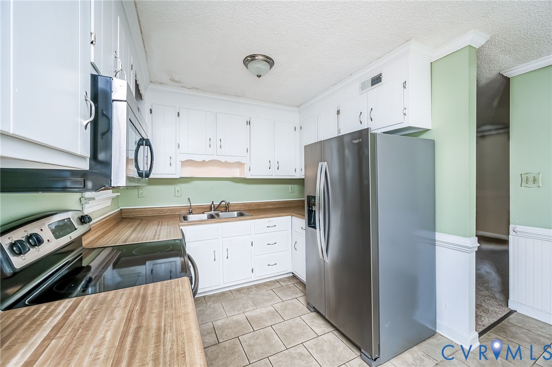 201 Monath Road Chesterfield, VA 23236 - Photo 17 of 30 a kitchen with a refrigerator and a stove