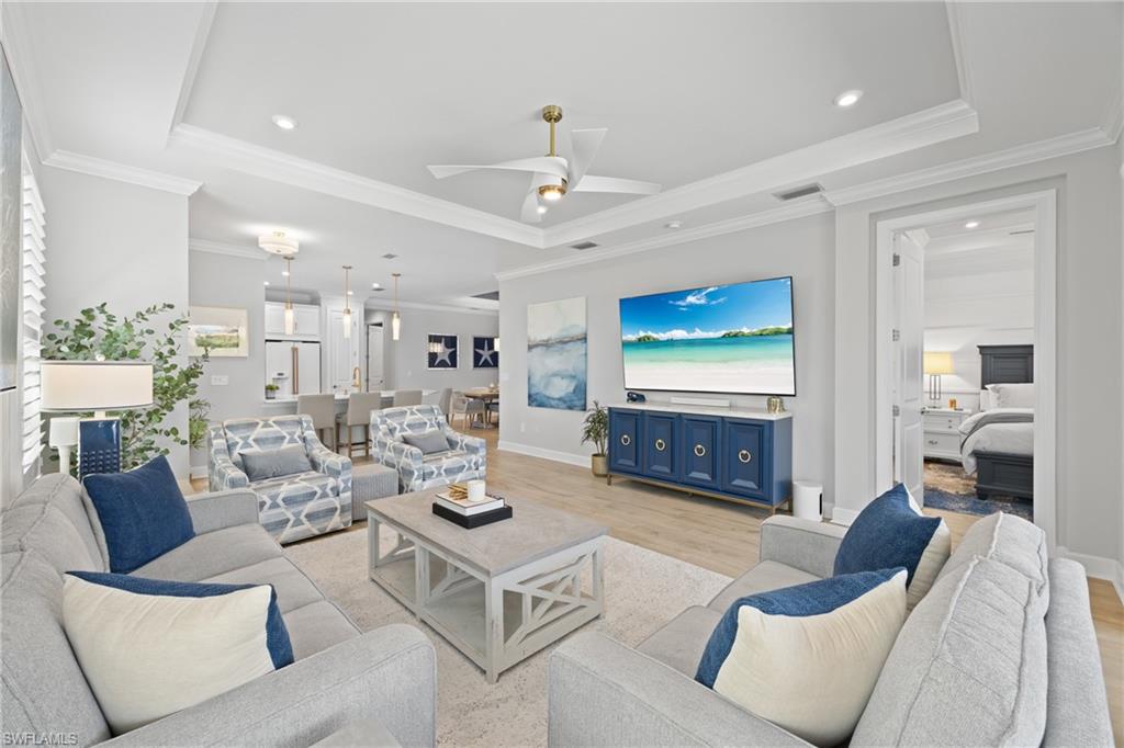 15214 Tolmino Street Naples, FL 34114 - Photo 1 of 47 a living room with furniture and a chandelier