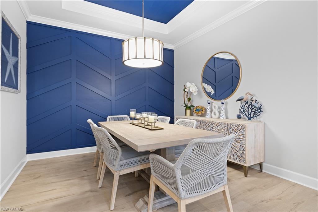 15214 Tolmino Street Naples, FL 34114 - Photo 11 of 47 a view of a dining room and a table and chairs