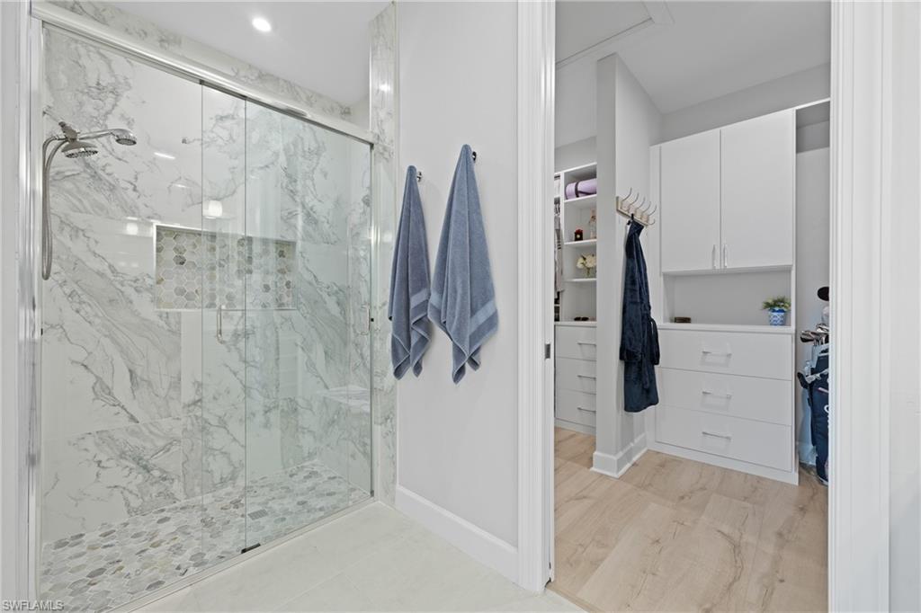 15214 Tolmino Street Naples, FL 34114 - Photo 16 of 47 a bathroom with a shower and a glass door