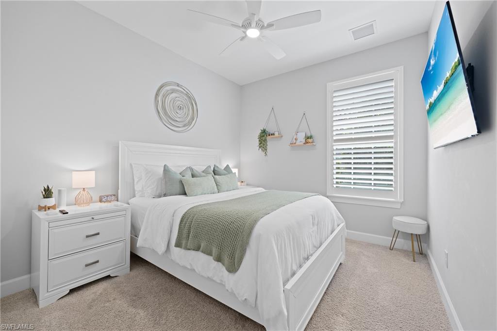 15214 Tolmino Street Naples, FL 34114 - Photo 18 of 47 a bedroom with a bed and a window