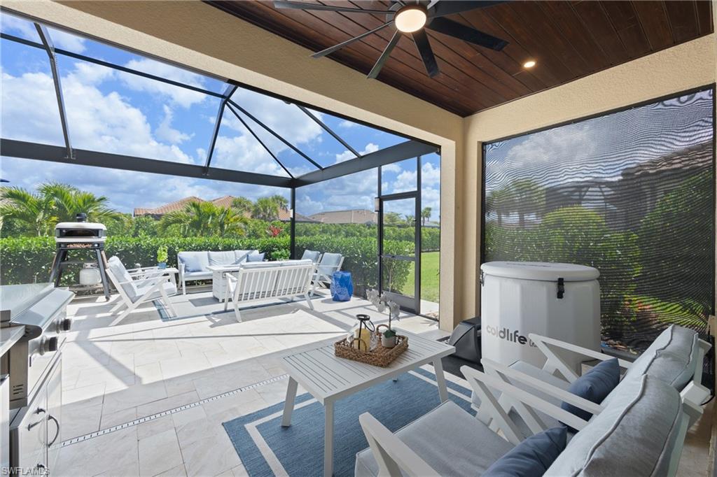 15214 Tolmino Street Naples, FL 34114 - Photo 22 of 47 a view of an outdoor dining space with furniture