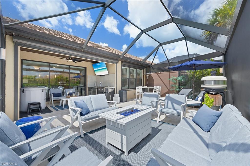 15214 Tolmino Street Naples, FL 34114 - Photo 24 of 47 a view of pool table and chairs in patio