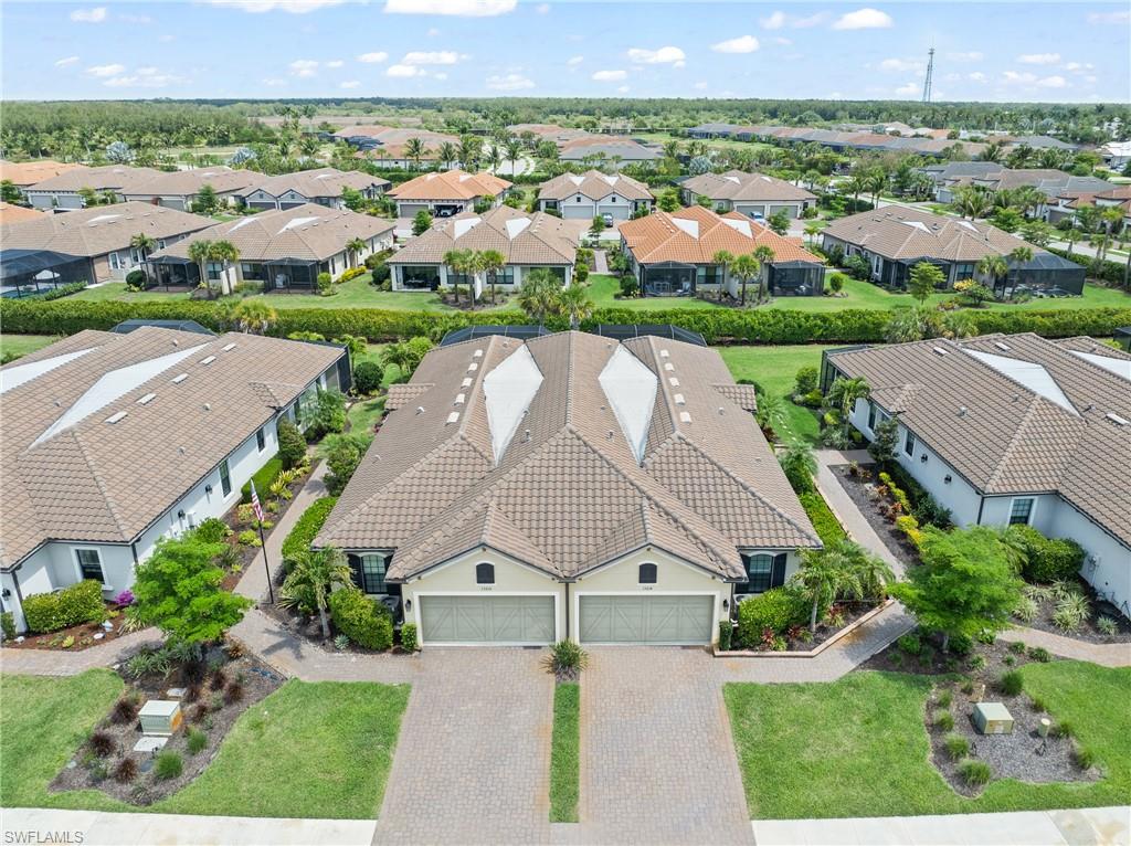 15214 Tolmino Street Naples, FL 34114 - Photo 32 of 47 an aerial view of a house with a yard