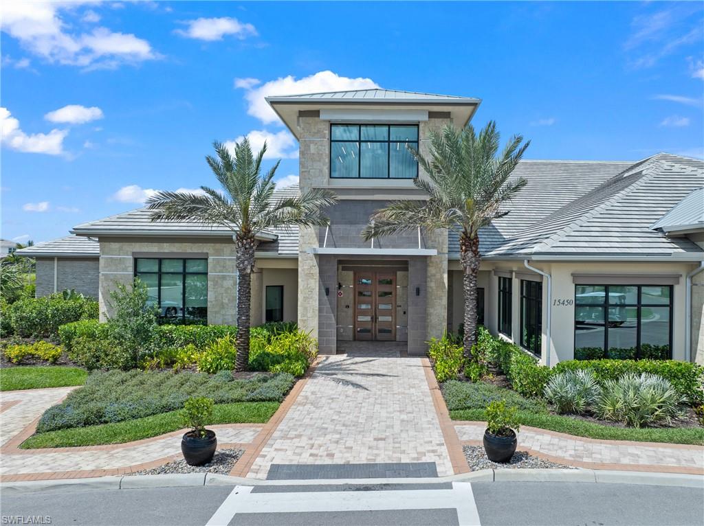 15214 Tolmino Street Naples, FL 34114 - Photo 46 of 47 a front view of a house with garden