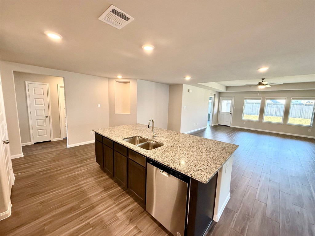 5322 Briana Dee Drive Rosharon, TX 77583 - Photo 7 of 20 a kitchen with stainless steel appliances granite countertop a sink stove and wooden floor