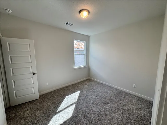 an empty room with closet and window