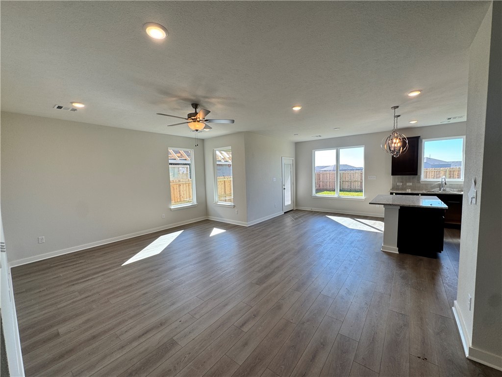 2409 Rooke Road Bryan, TX 77807 - Photo 6 of 11 a view of an empty room with a window and wooden floor