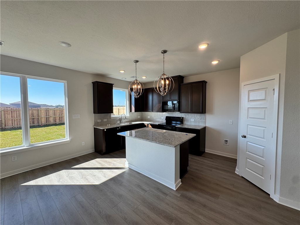 2409 Rooke Road Bryan, TX 77807 - Photo 7 of 11 a large kitchen with a large counter top space a sink stainless steel appliances and cabinets