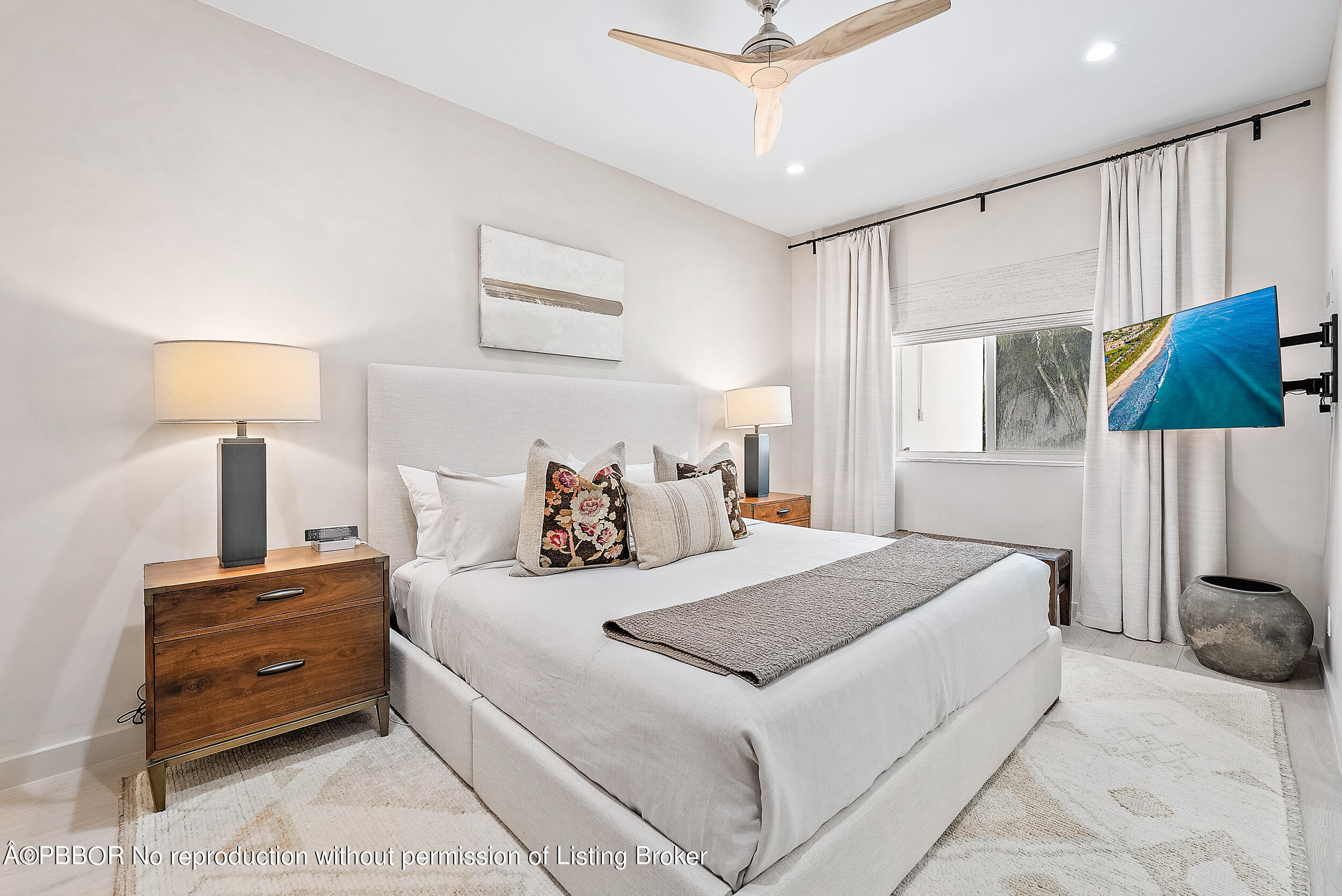 220 Atlantic Avenue, Unit 3 Palm Beach, FL 33480 - Photo 14 of 36 a bedroom with a bed and a lamp on dresser