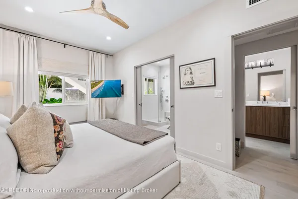 a bedroom with a bed and a large mirror