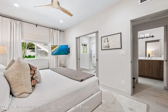 a bedroom with a bed and a large mirror