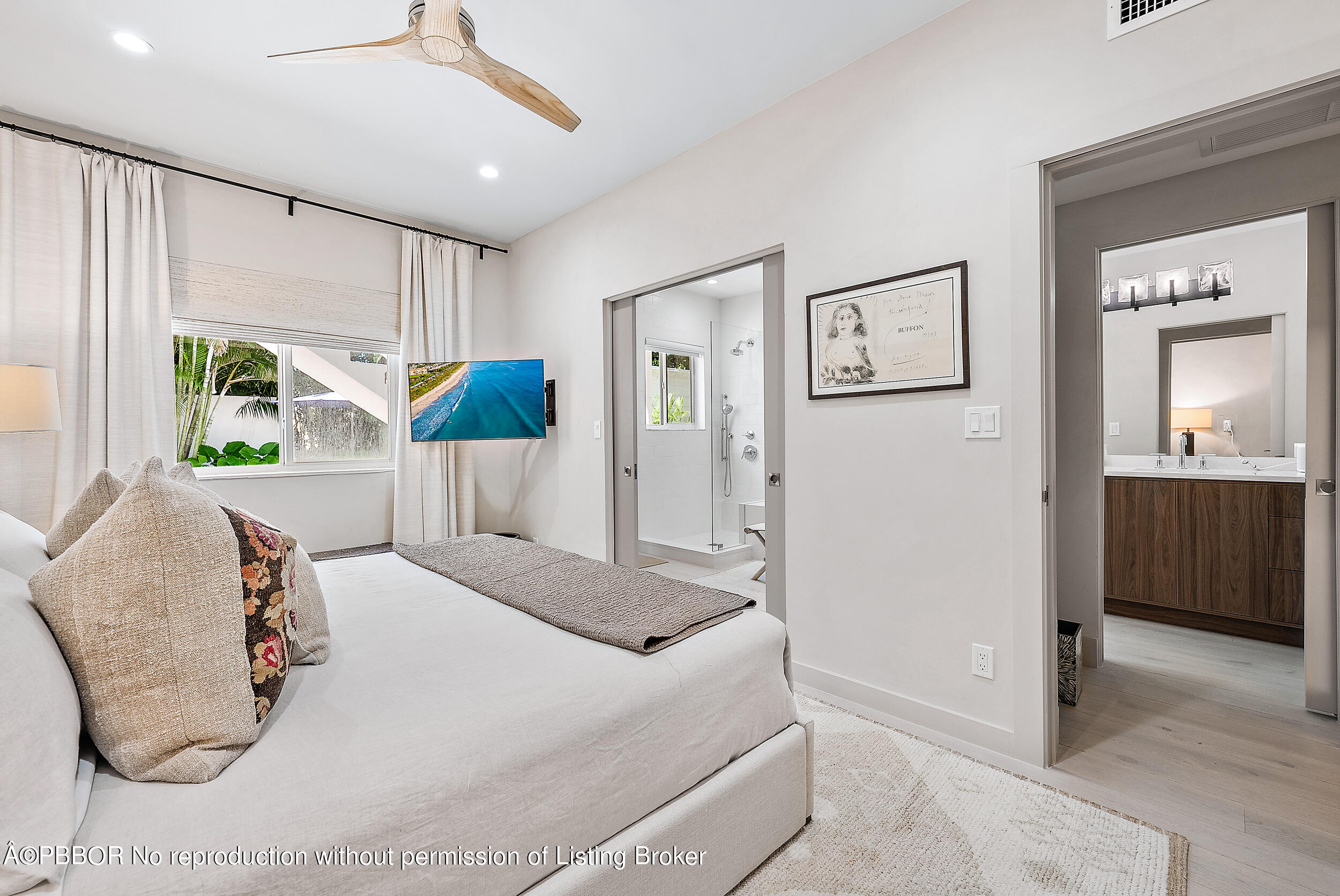 220 Atlantic Avenue, Unit 3 Palm Beach, FL 33480 - Photo 15 of 36 a bedroom with a bed and a large mirror