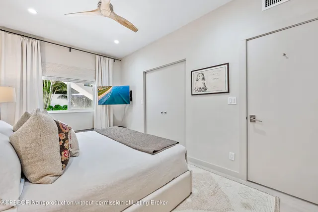 a bedroom with a bed and glass windows