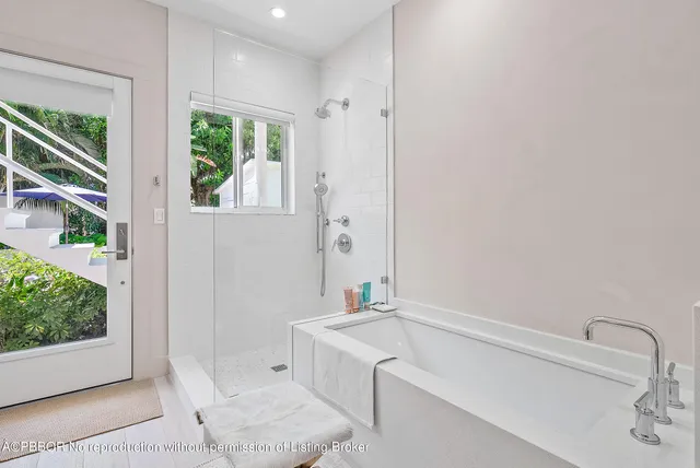 a bathroom with a tub sink and window