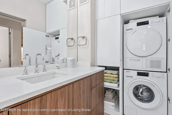 a en suite bathroom with a granite countertop sink and a mirror