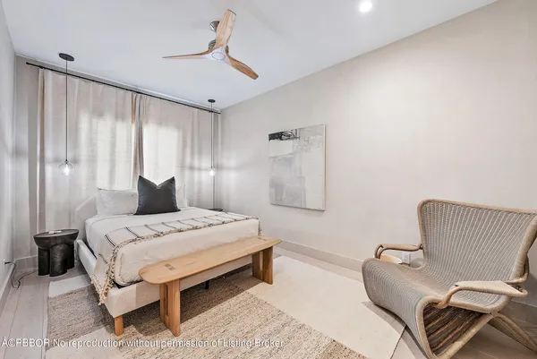 a bedroom with a bed and a couch