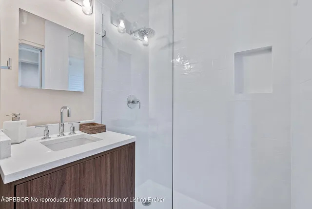 a bathroom with a sink vanity and a mirror