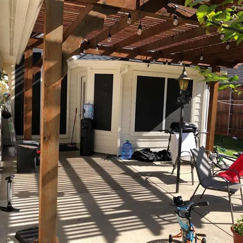 a view of a chairs and table in backyard