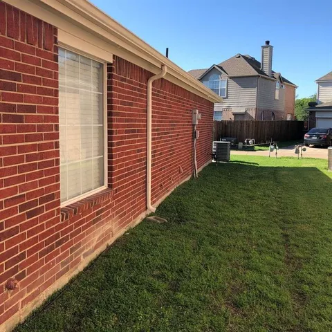 a view of a backyard with wooden fence