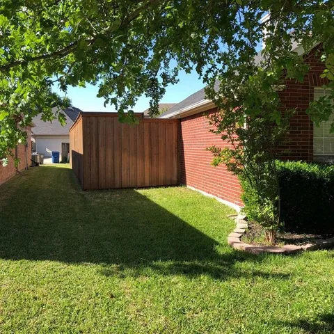a view of a house with a yard and plants