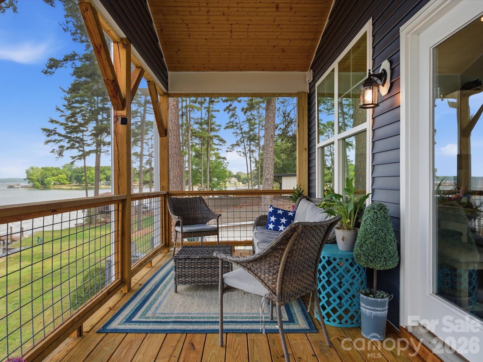 562 Lake Head Road Norwood, NC 28128 - Photo 23 of 43 a view of a balcony with chairs and wooden floor