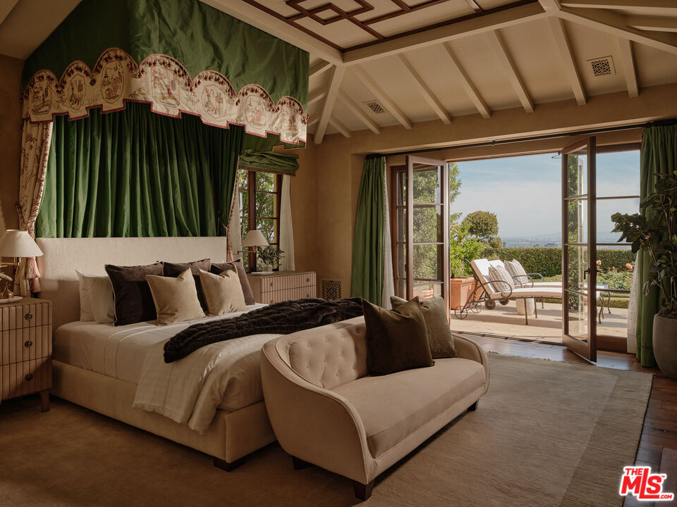 10939 Chalon Road Los Angeles, CA 90077 - Photo 11 of 24 a spacious bedroom with a bed and a large window