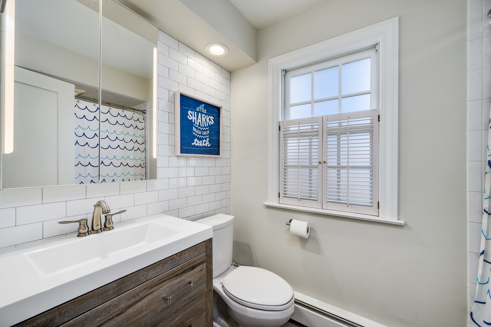2200 Swainwood Drive Glenview, IL 60025 - Photo 23 of 31 a bathroom with a sink a toilet and shower