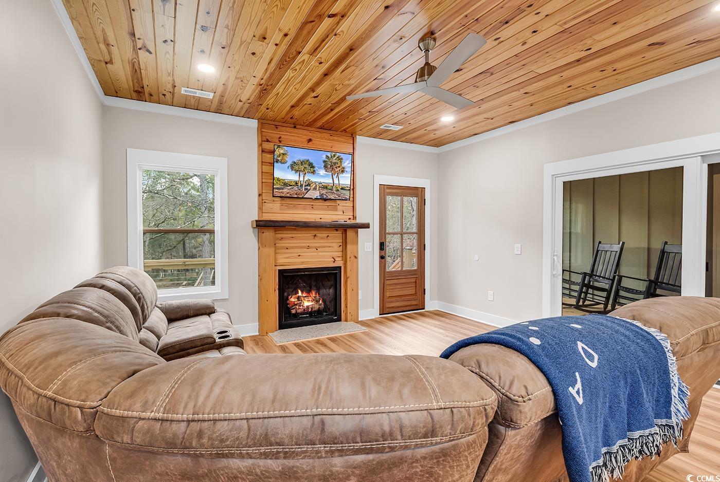 32 Old Place Kingstree, SC 29556 - Photo 6 of 40 Living area featuring wooden ceiling, recessed lighting, wood finished floors, ornamental molding, and a fireplace with flush hearth