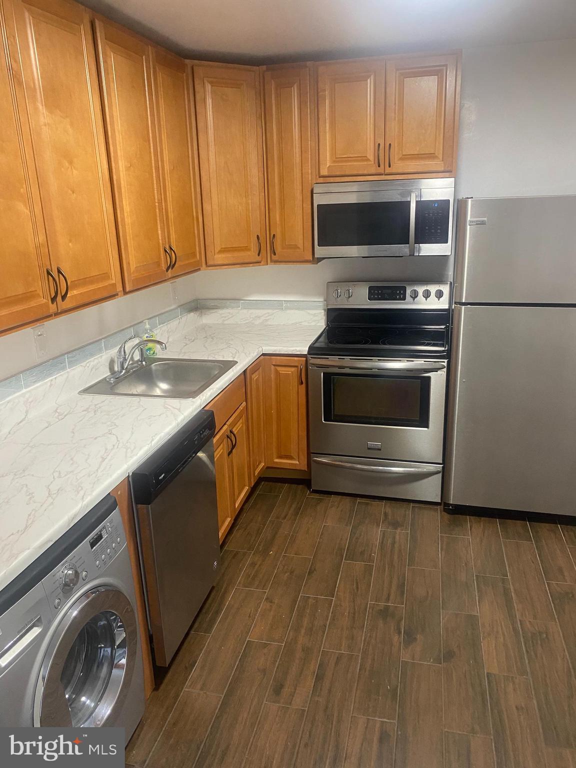 a kitchen with a sink and steel appliances
