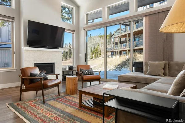 a living room with furniture fireplace and flat screen tv