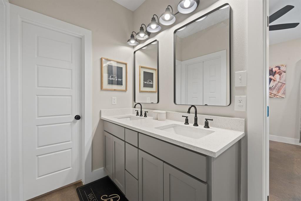 1031 Augustus Court Rio Vista, TX 76093 - Photo 11 of 30 Double vanity with light gray cabinetry, white countertops, and matte black fixtures