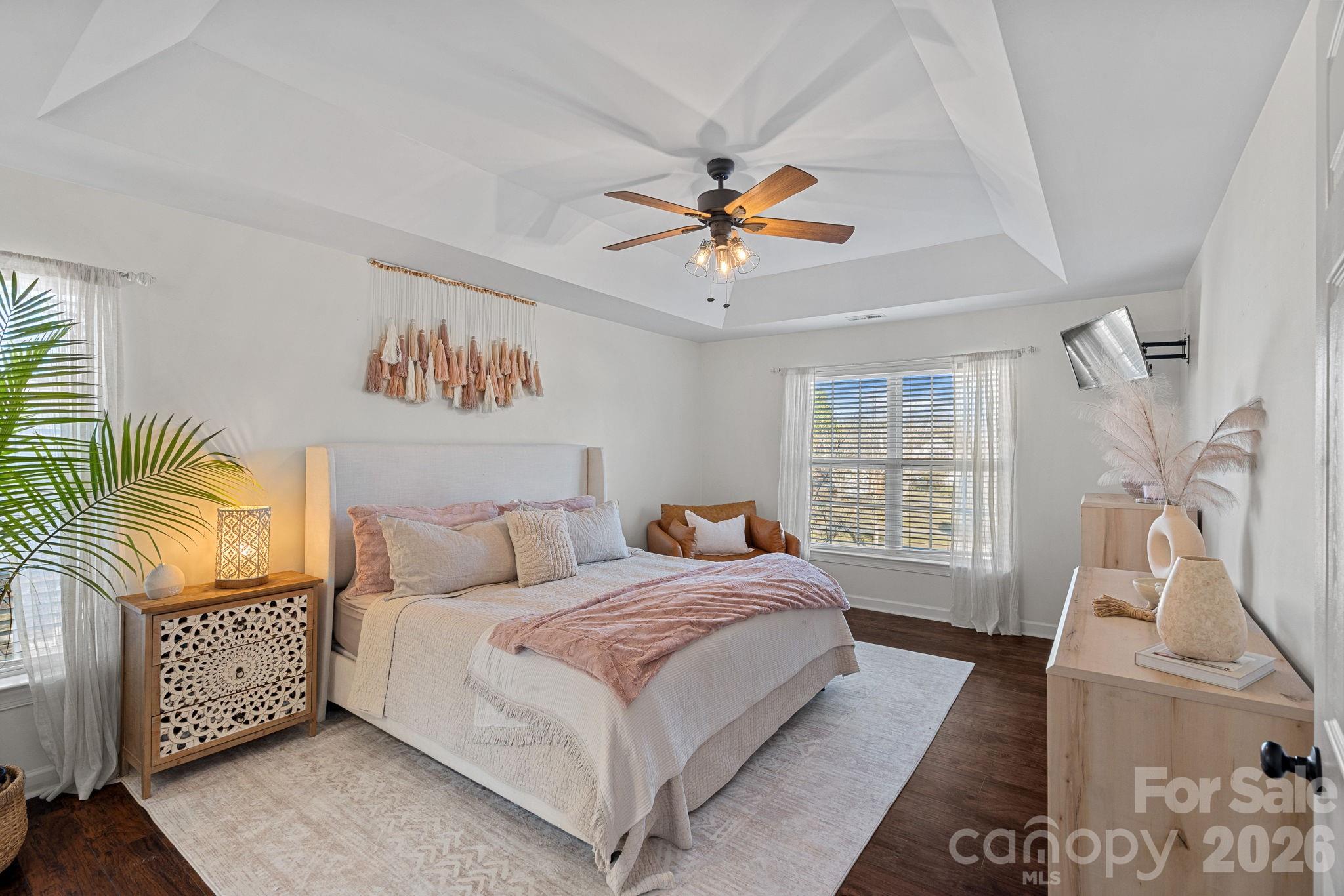 6110 Flowergate Lane Waxhaw, NC 28173 - Photo 20 of 39 a bedroom with a bed lamps flowerpot and window