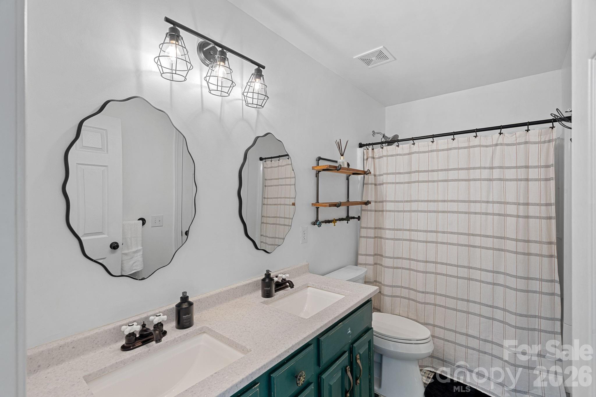 6110 Flowergate Lane Waxhaw, NC 28173 - Photo 27 of 39 a bathroom with a sink mirror toilet and shower