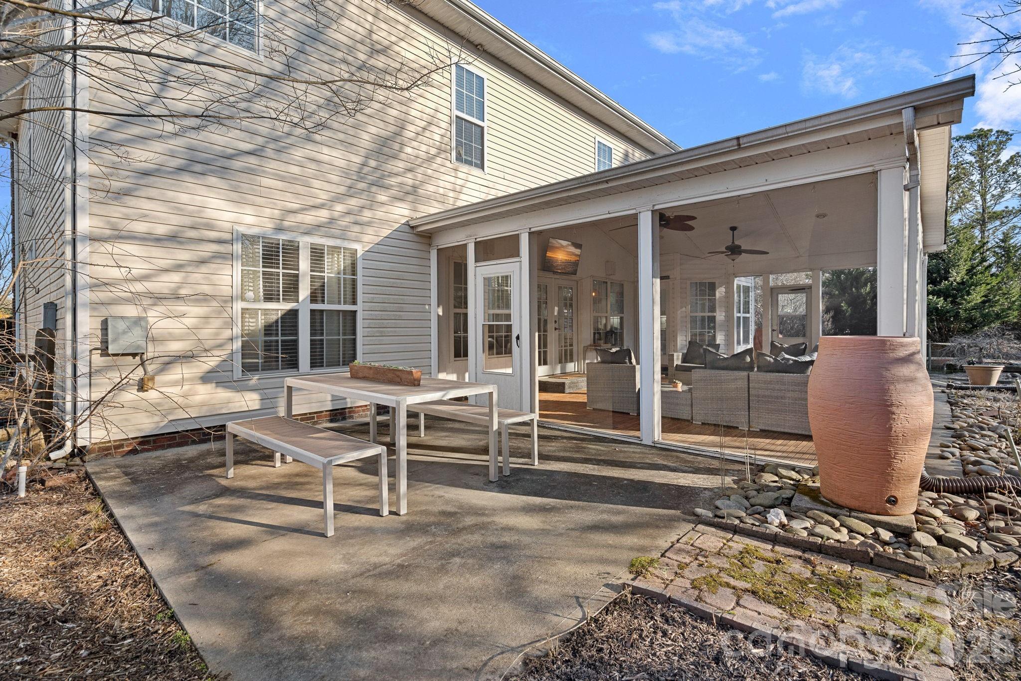 6110 Flowergate Lane Waxhaw, NC 28173 - Photo 31 of 39 a view of a patio with table and chairs and wooden fence