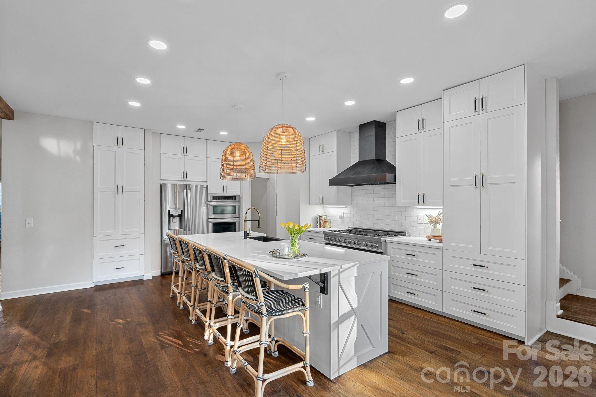 6110 Flowergate Lane Waxhaw, NC 28173 - Photo 4 of 39 a kitchen with stainless steel appliances kitchen island granite countertop a stove a sink and a refrigerator