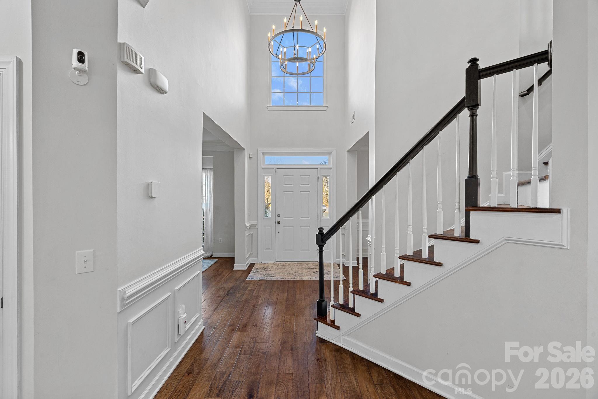 6110 Flowergate Lane Waxhaw, NC 28173 - Photo 10 of 39 a view of hallway with wooden floor and stairs