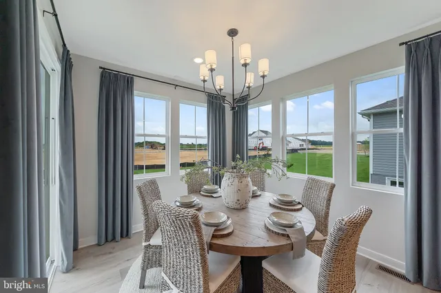 a view of a dining room with furniture large windows and wooden floor