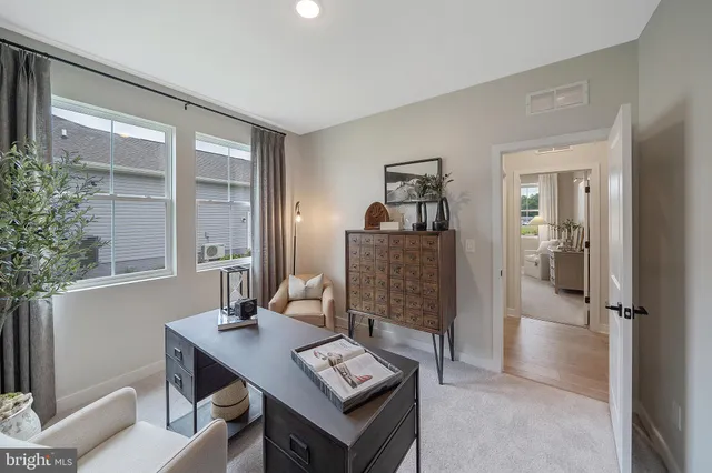 a view of a workspace with furniture and a potted plant