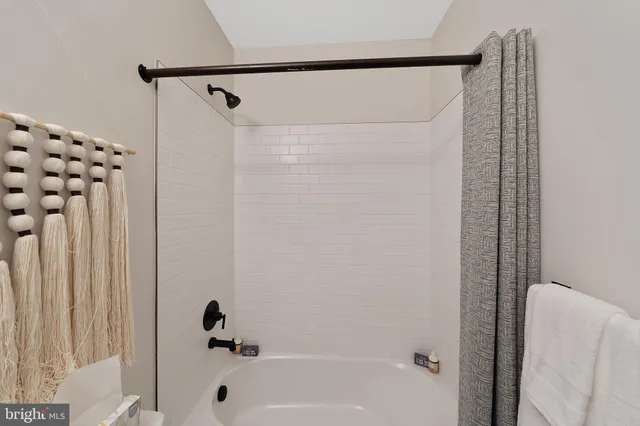 a bathroom with a shower and a tub
